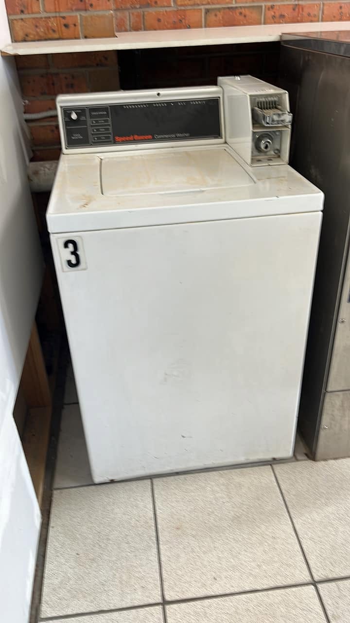 Coin-operated commercial washing machine at Melba Laundrette in Sunbury